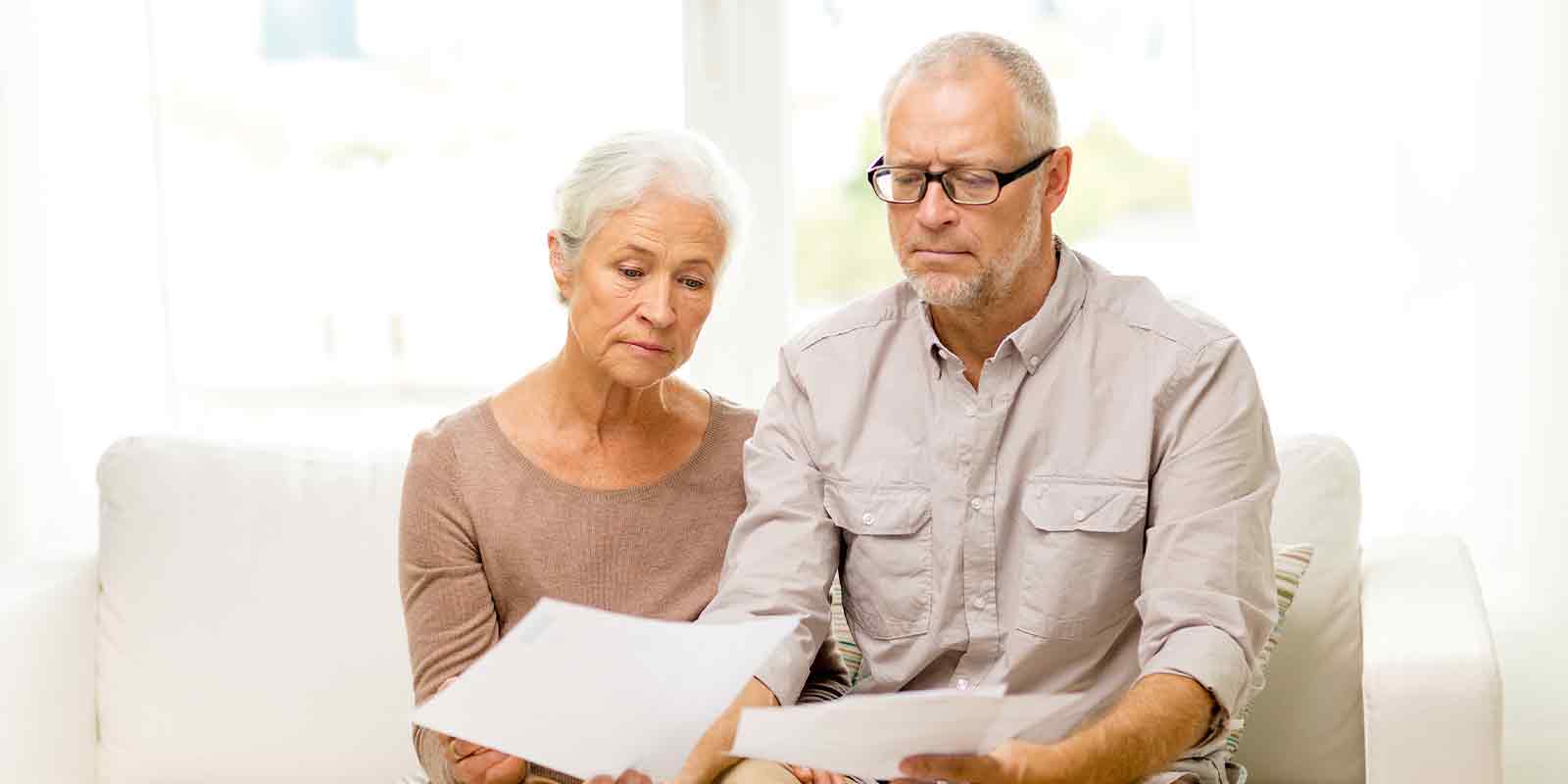 older couple looking at receipt