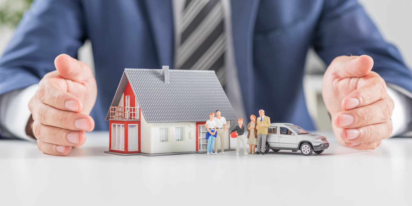 figurines of a family with a house and car representing estate protection