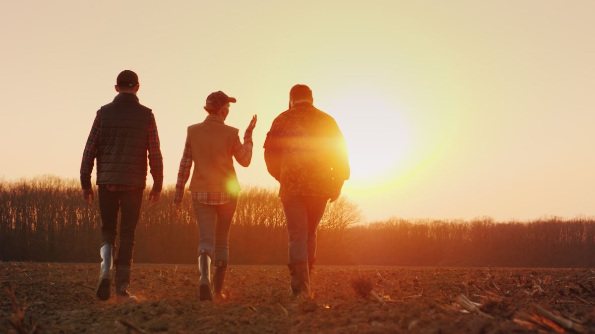 Family Business Owners Walking Through Field