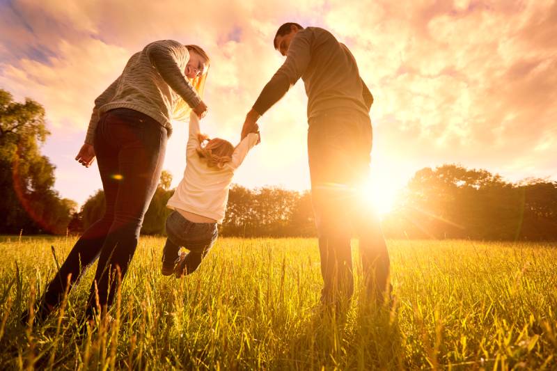 Family Having Fun In A Field