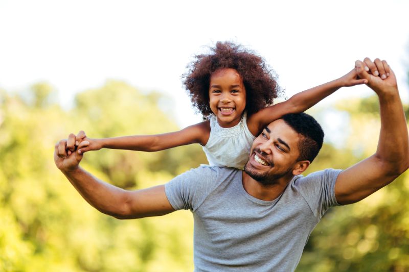Man Holding His Daughter After Acquiring A Term Life Insurance Policy