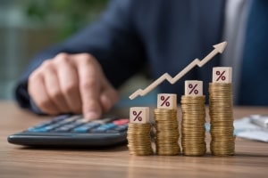 Person Calculating Investment Rate with Graph Percentage