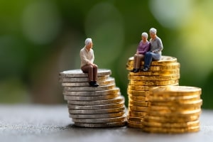 Seniors Sitting on Coin Stacks Representing Retirement Income
