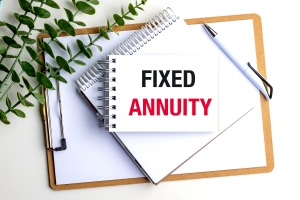 Notebook with Words Fixed Annuity on Clipboard