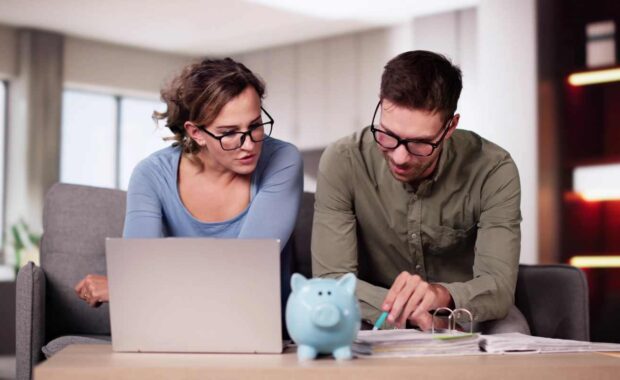 Couple Checking Fixed Annuity vs Employer Sponsored Plans for Retirement